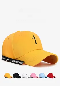 Detailed view of embroidery cross and long decorative strap on cotton baseball cap