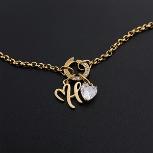 Elegant gold titanium steel necklace with artistic letter H and heart crystal pendant