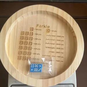 Farkle round wooden dice tray with laser-engraved scoring rules and six blue dice