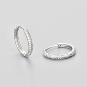 Macro detail of silver circle earrings featuring micro-pave cubic zirconia crystals
