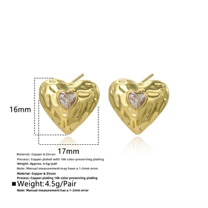 Detail view of 16mm gold heart stud earrings with cubic zirconia and hammered texture