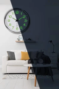 Detailed comparison of 12-inch wall clock in bright daylight and green luminous night mode