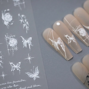White butterfly and rose embossed nail decals on matte translucent long coffin nails