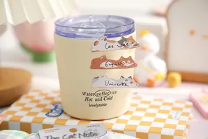 Cute cat stickers on a cream-colored mug with purple lid in a cozy desktop scene