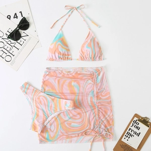 Detailed macro view of three-piece printed bikini set with drawstring beach skirt