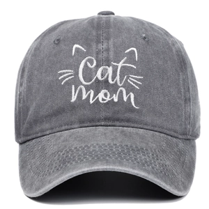 Close-up of Cat Mom white embroidery on vintage washed dark grey baseball cap fabric