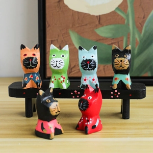Set of 6 colorful Nordic hand-painted wooden cat figurines on a black display bench