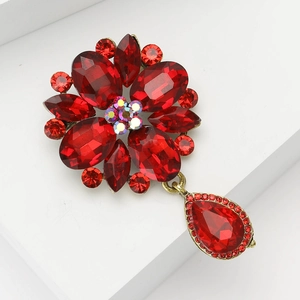 Vintage gold alloy brooch with red crystals and teardrop pendant for elegant dresses