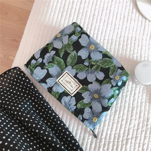 Detailed macro of vintage floral jacquard pouch with Time To Party woven label detail