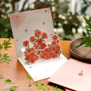 3D pop-up greeting card featuring a blooming red rose bouquet with a pink envelope