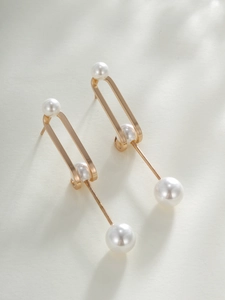 Detailed 45-degree angle view of gold drop earrings with four white pearls and zircon