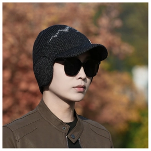 Detailed view of dark gray fleece-lined knit winter hat with protective ear flaps