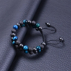 Detail of double-layer woven bracelet with blue tiger eye and black lava stone beads
