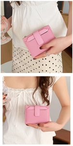 Detail of pink woven leather wallet held by model showing compact bi-fold zip design