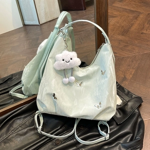 Mint green large capacity tote backpack with butterfly metal accents and cloud charm