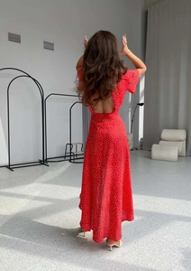 Detailed back view of a red polka dot midi dress showing backless design and ruffles