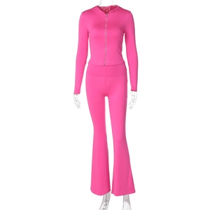 Full view of pink two-piece tracksuit featuring a hooded zip-up jacket and flared pants