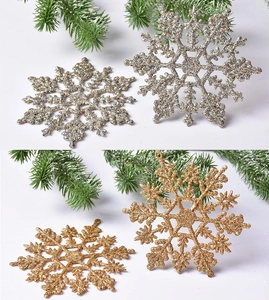 Close-up of sparkling gold and silver glitter snowflake ornaments for Christmas decor