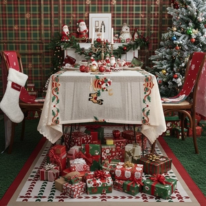 Festive Christmas tablecloth with Santa, reindeer embroidery in a warm holiday dining room