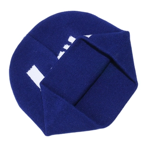 Detail of dark blue knit beanie featuring white jacquard patterns and fine texture