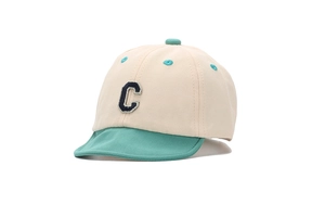 Detail of baby color-block baseball cap featuring soft cotton fabric and embroidered letter C
