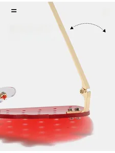 Detail of durable gold metal hinge and red perforated lenses on funny hip-hop sunglasses