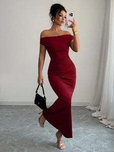 Close-up of elegant off-shoulder evening dress with ruched waist in dark red