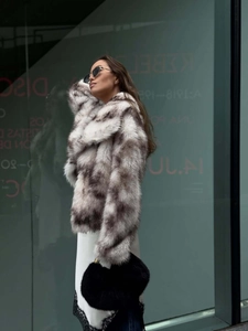 Detail of faux fur coat with black and white spotted texture on fashionable outerwear