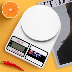 Top view of SF-400 digital kitchen scale with 10kg capacity on a vibrant yellow background