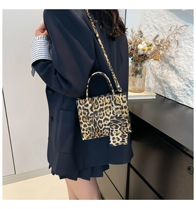 Detail of leopard print handbag featuring a matching mini coin purse and shoulder strap