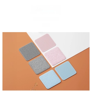 Detail of square non-slip sofa cushion pads in grey, pink, and light blue fabric textures