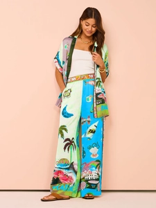 Detail of vibrant tropical print casual set with wide-leg trousers and silk-like texture
