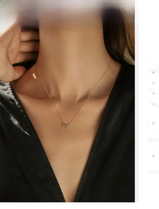 Detail of 444 angel number pendant with sparkling crystals on gold chain necklace