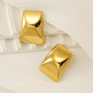 Macro shot of 18k gold plated stainless steel geometric earrings on white cloth