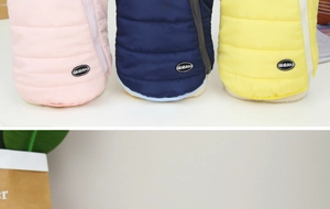 Detailed display of warm padded pet vests in pink, navy, and yellow with zipper closure