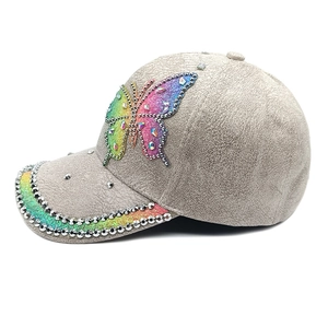Close-up of suede baseball cap with iridescent sequin butterfly and silver rhinestones