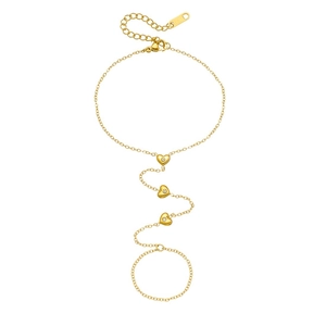 Gold stainless steel heart slave bracelet with glittering rhinestones on white backdrop