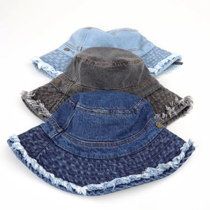 Three distressed denim bucket hats with frayed edges in light blue, charcoal, and dark blue