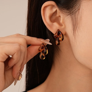 Close-up of vintage resin water drop earrings with tortoiseshell leopard print