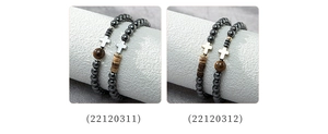 Detailed view of beaded hematite bracelets featuring metal cross pendants in two styles