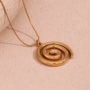 Gold plated stainless steel spiral pendant necklace with elegant snake chain on pink background