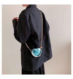 Mini sac bandoulière bleu clair en forme de cœur avec perles et chaîne dorée sur mannequin