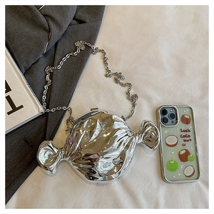 Detailed view of candy-shaped silver acrylic bag with metallic finish and chain strap