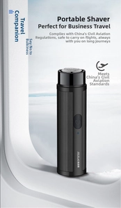 Close-up of portable mini electric shaver for men on an airplane window ledge with clouds