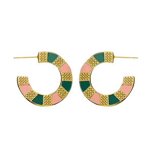 Detailed macro view of gold-plated C-shaped hoop earrings with colorful enamel and dot texture