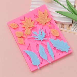 Pink silicone leaf mold for DIY cake decorating featuring multiple foliage shapes