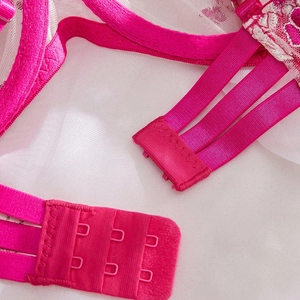 Close-up of rose pink lace bra back with three-row hook-and-eye closure and triple straps