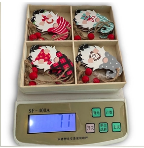 Detailed view of four Nordic Christmas gnomes in a wooden storage box with hemp strings