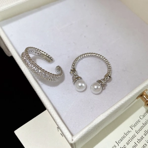 Detail of silver-plated adjustable ring featuring elegant pearls and zircon paving