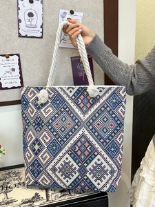 Ethnic bohemian tote bag with blue geometric patterns and white rope handles